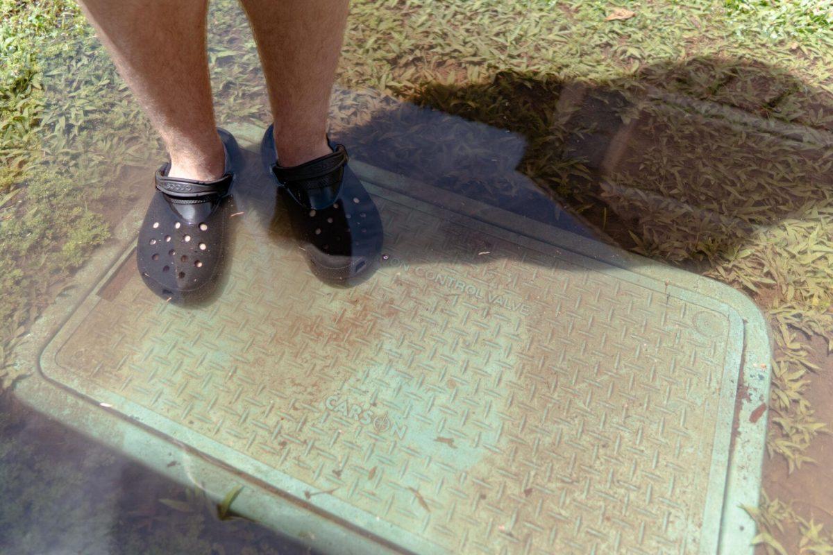 A headless shadow extends from the body of sophomore animal sciences major Joey Grana on Thursday, April 14, 2022, outside of the East Campus Apartments on Veterans Drive in Baton Rouge, La.