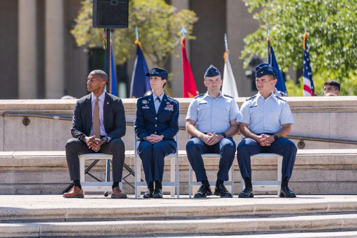 President Tate sits with members of the LSU ROTC on Thursday, April 7, 2022, as the change of command ceremony begins on the LSU Parade Ground on Highland Road in Baton Rouge, La.