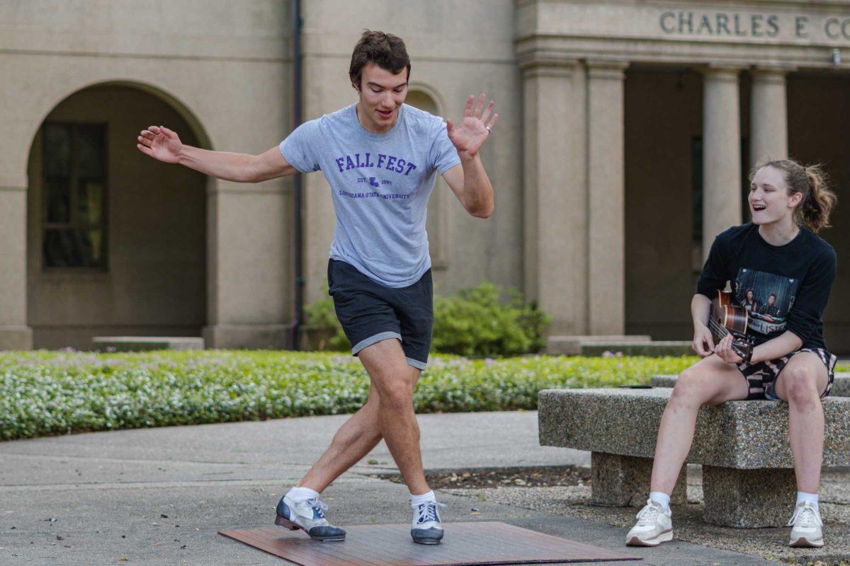 LSU sophomore math major Harrison Gietz (left) and sophomore film and tv major Jackie Johnston (right) perform a song and dance on Saturday, April 23, 2022, outside of Coates Hall in the Quad in Baton Rouge, La.