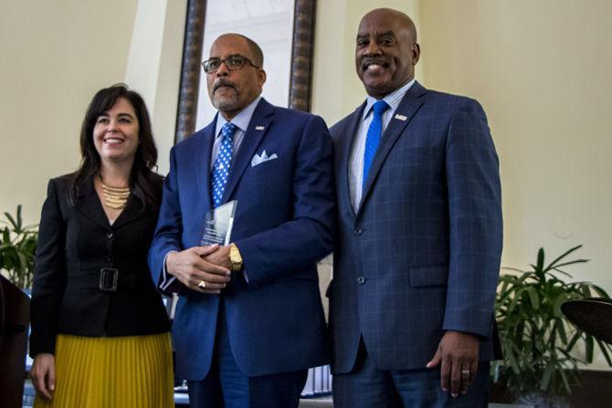 (from left to right) Senior vice president of principal gifts and CFRE Ann Marie Marmande helps present the Kuumba Community Service Award to Rev. Dr. Herman Kelly of Bethel Ame Church alongside vice provost for diversity and chief diversity officer Dr. Dereck J. Rovaris at the Clarence L. Barney, Jr. African American Cultural Center (AACC) Jazz Brunch on Saturday, Feb. 24, 2018, in the LSU Club at Union Square.