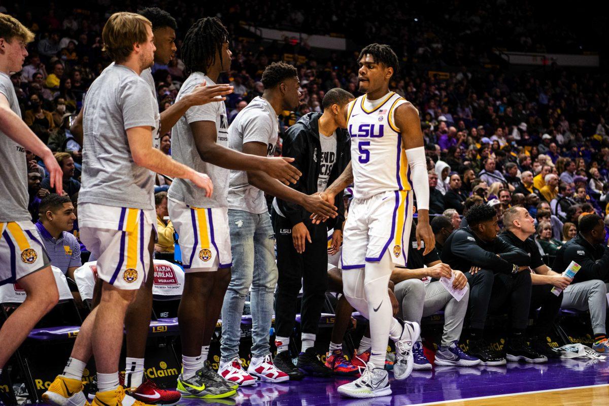 LSU men&#8217;s basketball sophomore forward Mwani Wilkinson (5) high-fives his teams as he approaches the bench Wednesday, Jan. 26, 2022, during LSU&#8217;s 70-64 win against Texas A&amp;M in the Pete Maravich Assembly Center on North Stadium Drive in Baton Rouge, La.