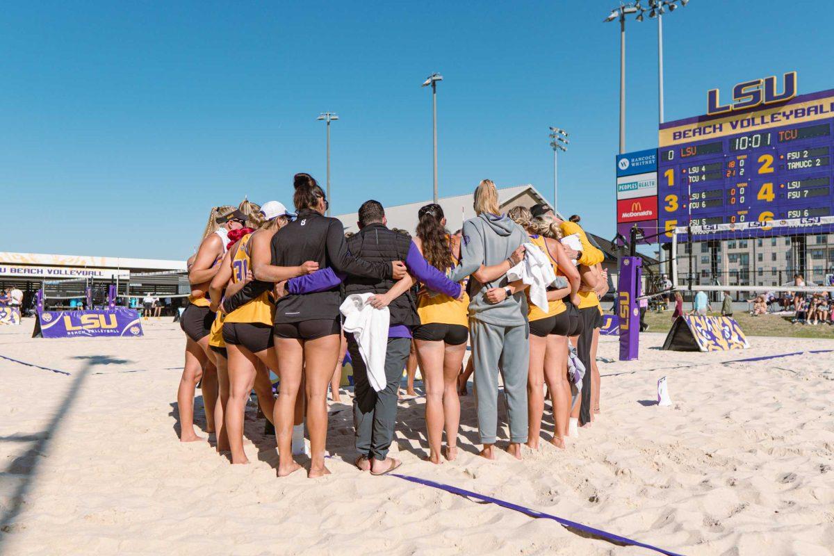 The LSU beach volleyball team huddles up prior to their match on Sunday, March 27, 2022, against TCU at the Beach Volleyball Stadium on Cypress Drive in Baton Rouge, La.