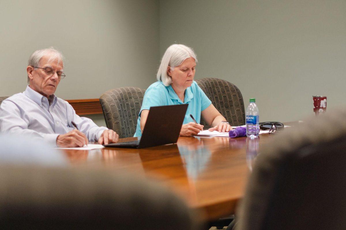 LSU Faculty Senate Past-President Kenneth McMillin (left) and Vice-President Joan King (right) take notes on Wednesday, April 20, 2022, during the LSU Faculty Senate Executive Committee meeting inside the LSU Student Union on Highland Road in Baton Rouge, La.