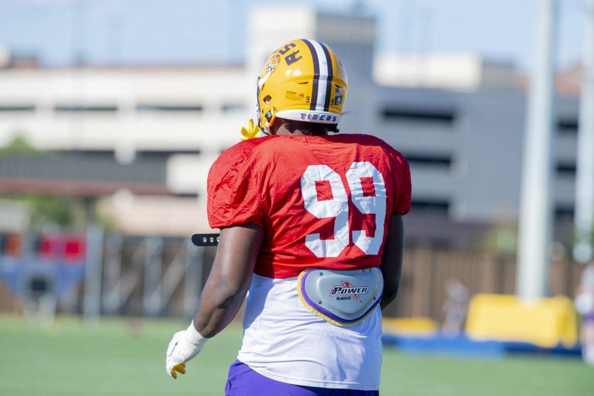 LSU football defensive tackle Jaquelin Roy (99) stands on the sidelines Thursday, April 7, 2022, during LSU&#8217;s spring practice in Baton Rouge, Louisiana.