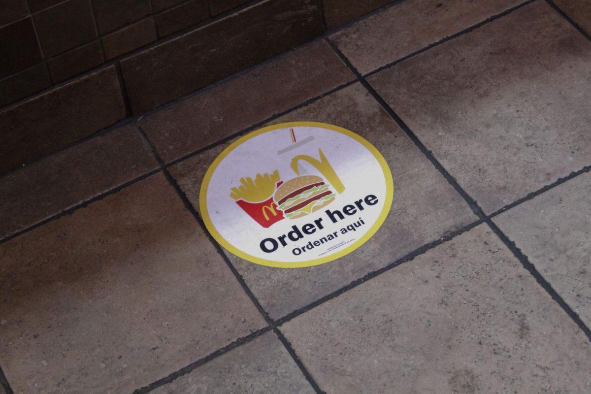 The "Order Here" floor sticker sits on the ground on Friday, April 8, 2022, at the LSU Student Union in Baton Rouge, La.