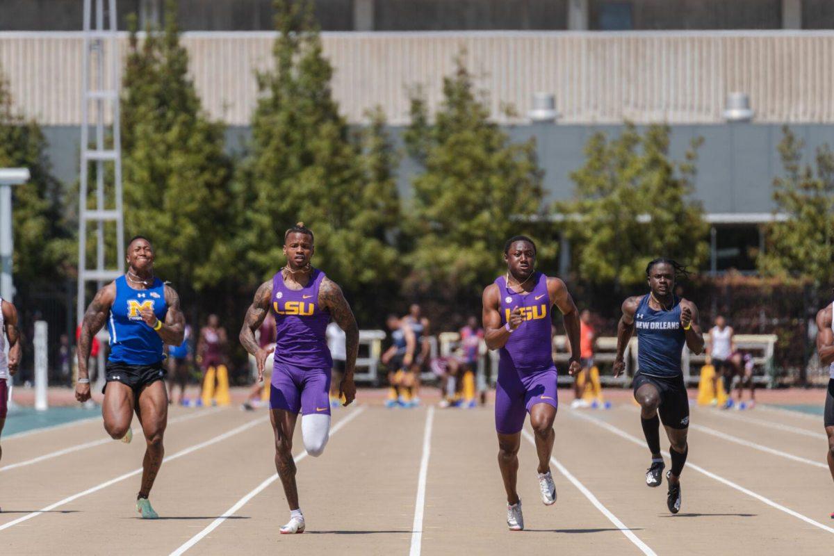 LSU track and field sprints junior Dorian Camel (left) and sprints sophomore Da&#8217;Marcus Fleming (right) race down the track on Saturday, April 2, 2022, during the 100m dash at the Battle on the Bayou track meet at Bernie Moore Stadium in Baton Rouge, La.