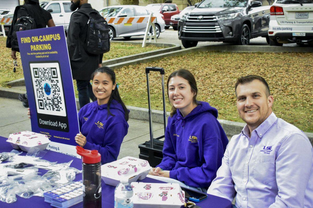 LSU&#8217;s Parking and Transportation team poses for a picture with a QR code to the new ParkZen app Monday, April 11, 2022, on Tower Drive in Baton Rouge, Louisiana.