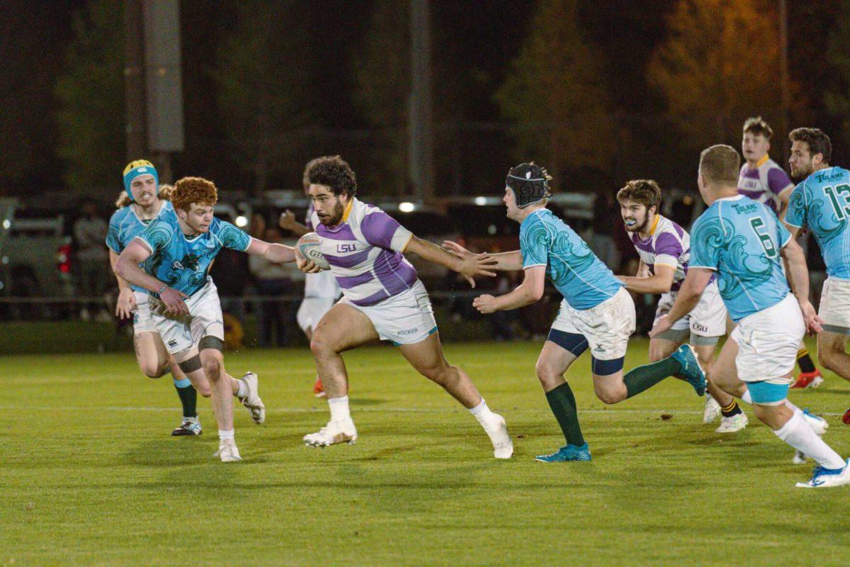 LSU Rugby flanker Diego Carrera breaks through the defenders on Friday, April 8, 2022, during LSU&#8217;s 89-0 win over Tulane at the UREC Fields on Gourrier Avenue in Baton Rouge, La.