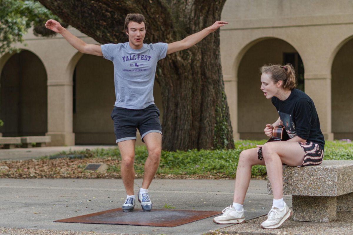 LSU sophomore math major Harrison Gietz (left) and sophomore film and tv major Jackie Johnston (right) perform a song and dance on Saturday, April 23, 2022, outside of Coates Hall in the Quad in Baton Rouge, La.