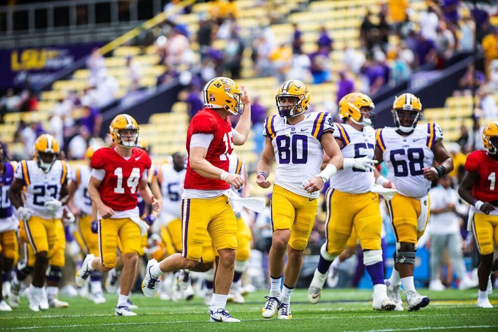 LSU football fifth-year senior quarterback Myles Brennan (15) and sophomore wide receiver Jack Bech (80) celebrate Saturday, April 23, 2022, after LSU football&#8217;s annual spring football game with White winning&#160;51-31 over Purple in Tiger Stadium.