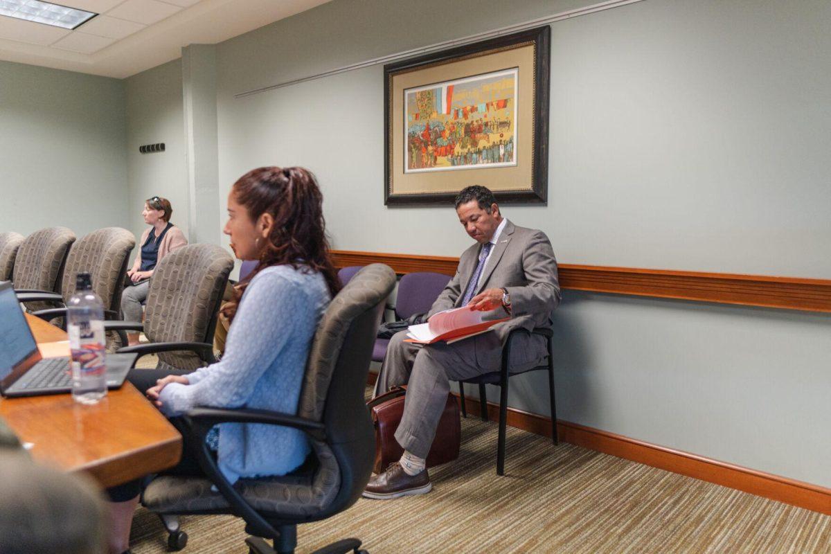 A lawyer present at the meeting flips through his folder on Wednesday, April 20, 2022, during the LSU Faculty Senate Executive Committee meeting inside the LSU Student Union on Highland Road in Baton Rouge, La.