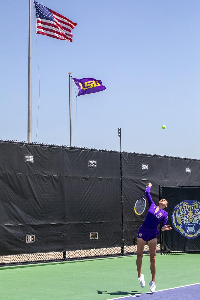 LSU women&#8217;s tennis graduate student Taylor Bridges toss the ball up to serve Friday, April 8, 2022, during LSU&#8217;s 7-0 loss against Texas A&amp;M in the LSU Tennis Complex on Gourrier Avenue in Baton Rouge.