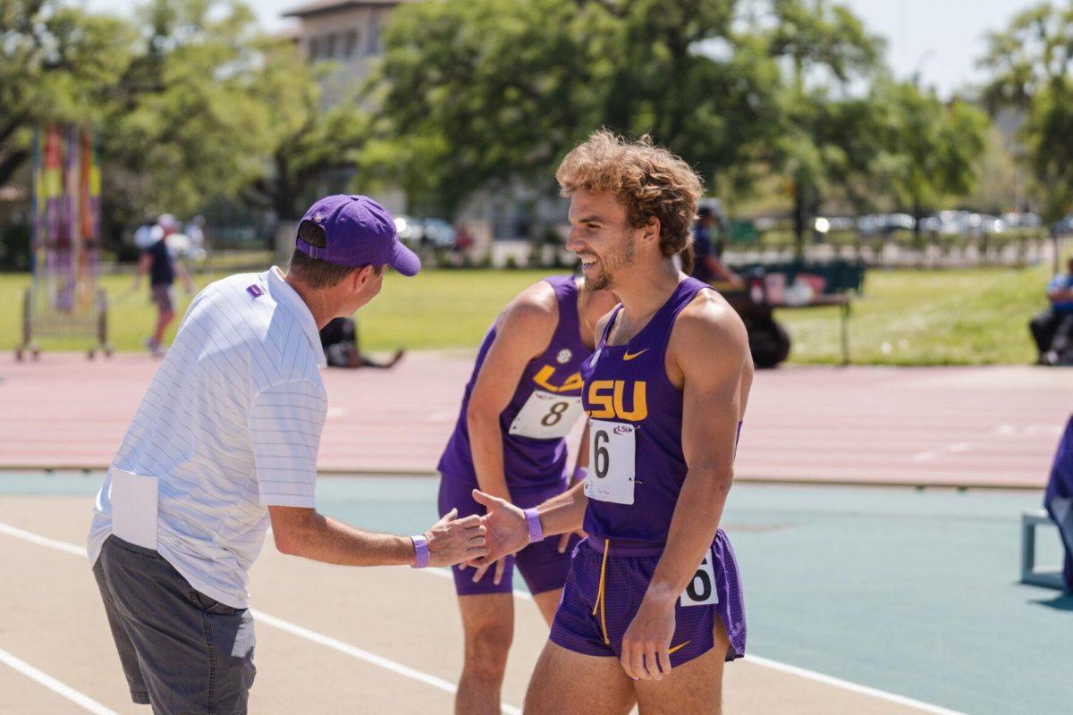 LSU track and field distance junior Adam Wise high fives his coach on Saturday, April 2, 2022, after the 800m run at the Battle on the Bayou track meet at Bernie Moore Stadium in Baton Rouge, La.