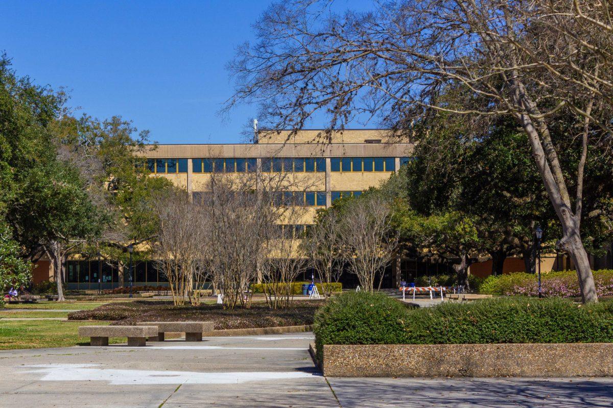 The LSU Library peeks through trees Wednesday, March 2, 2022, in the Quad.