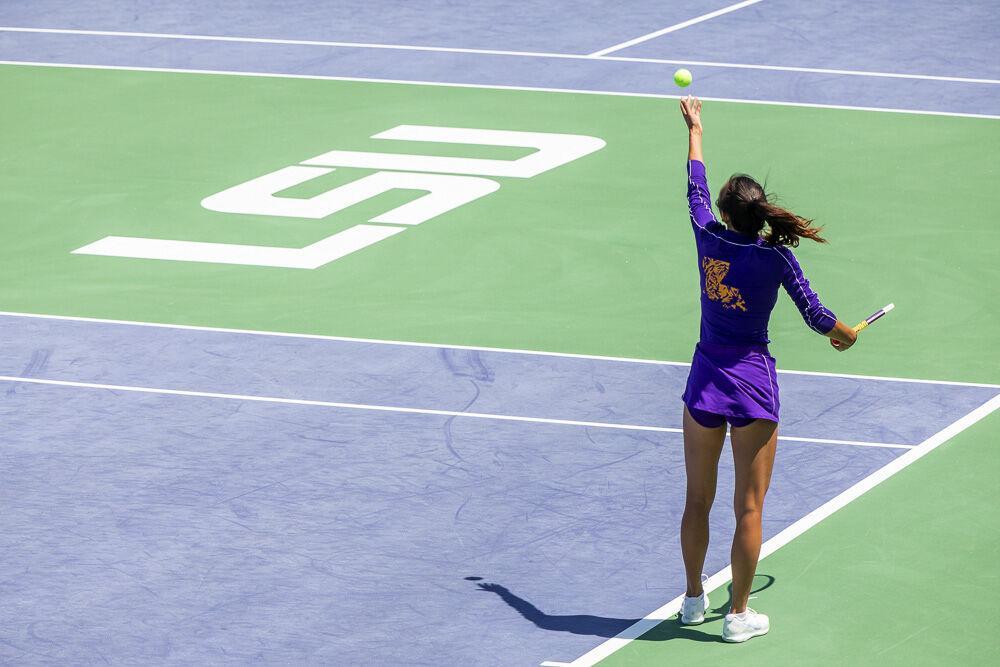 LSU women&#8217;s tennis graduate student Taylor Bridges toss the ball up to serve Friday, April 8, 2022, during LSU&#8217;s 7-0 loss against Texas A&amp;M in the LSU Tennis Complex on Gourrier Avenue in Baton Rouge.