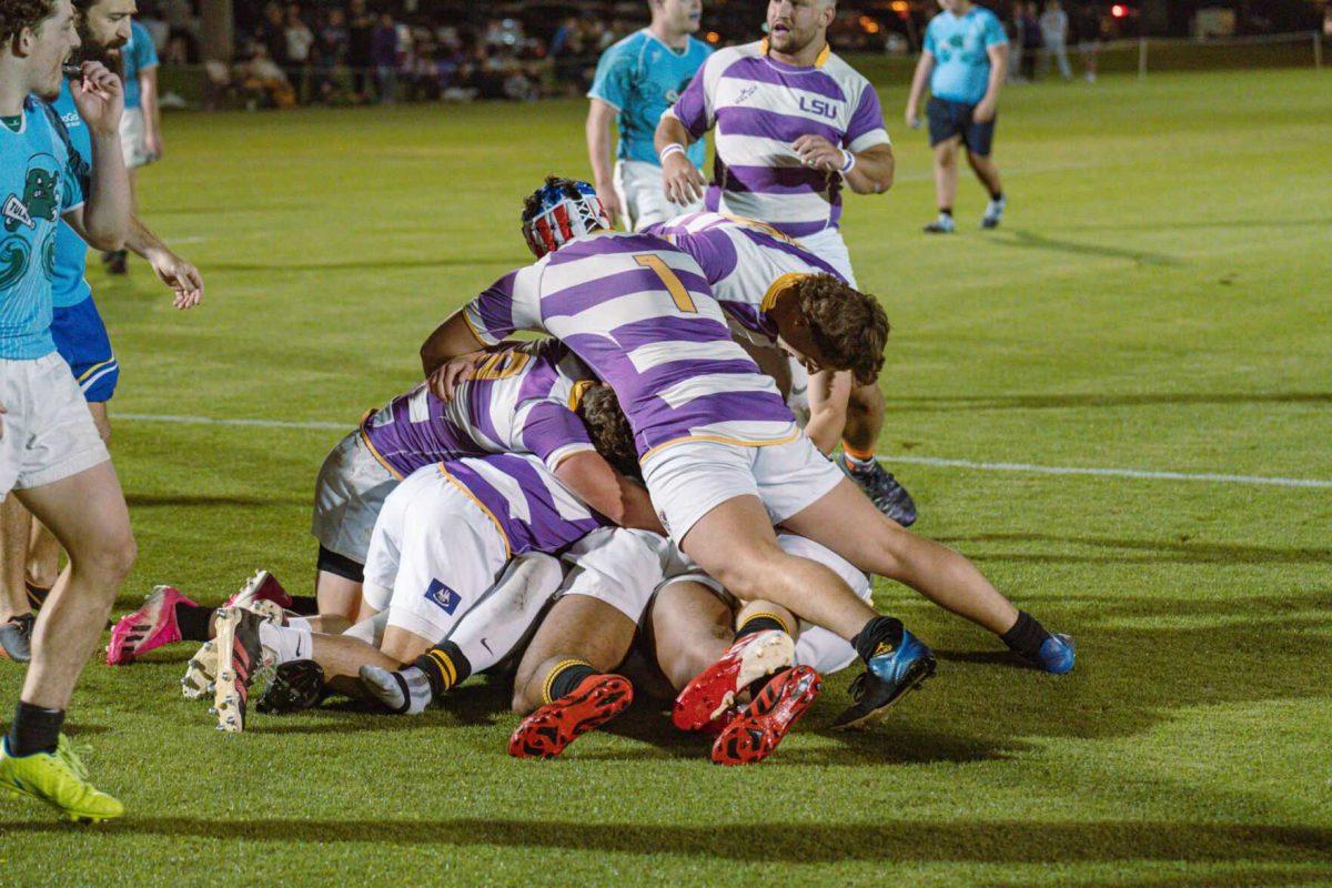 The LSU Rugby team piles on top of John Salyer in celebration on Friday, April 8, 2022, during LSU&#8217;s 89-0 win over Tulane at the UREC Fields on Gourrier Avenue in Baton Rouge, La.