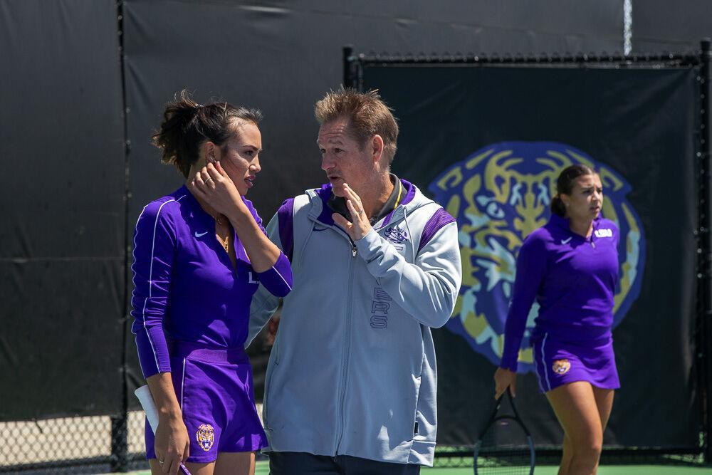 LSU women&#8217;s tennis co-head coach Michael Sell speaks with graduate student Taylor Bridges before the next serve Friday, April 8, 2022, during LSU&#8217;s 7-0 loss against Texas A&amp;M in the LSU Tennis Complex on Gourrier Avenue in Baton Rouge.