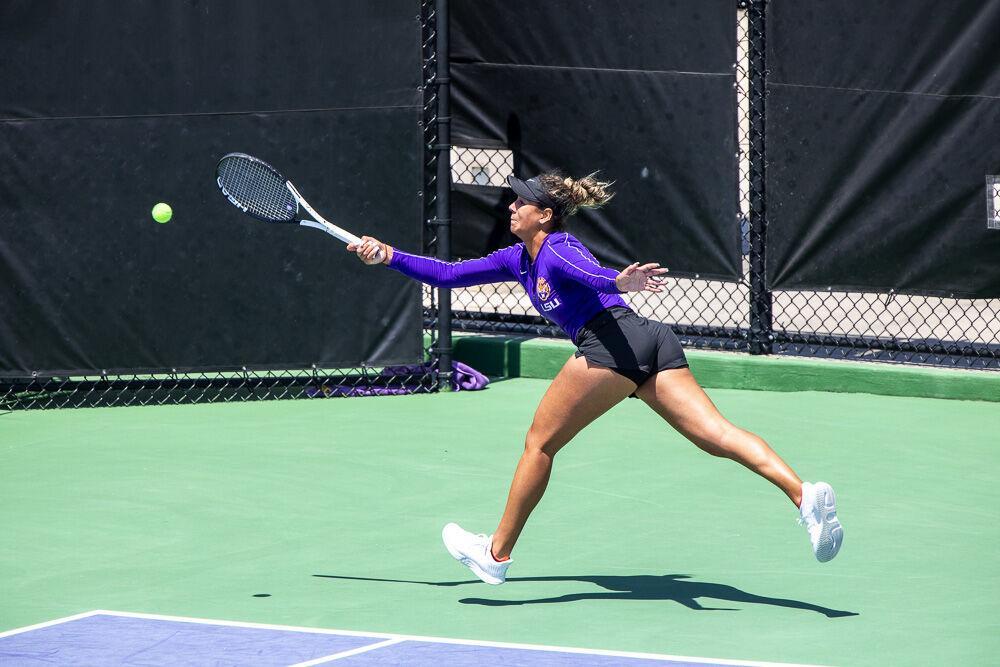 LSU women&#8217;s tennis junior Safiya Carrington reaches to return the ball Friday, April 8, 2022, during LSU&#8217;s 7-0 loss against Texas A&amp;M in the LSU Tennis Complex on Gourrier Avenue in Baton Rouge