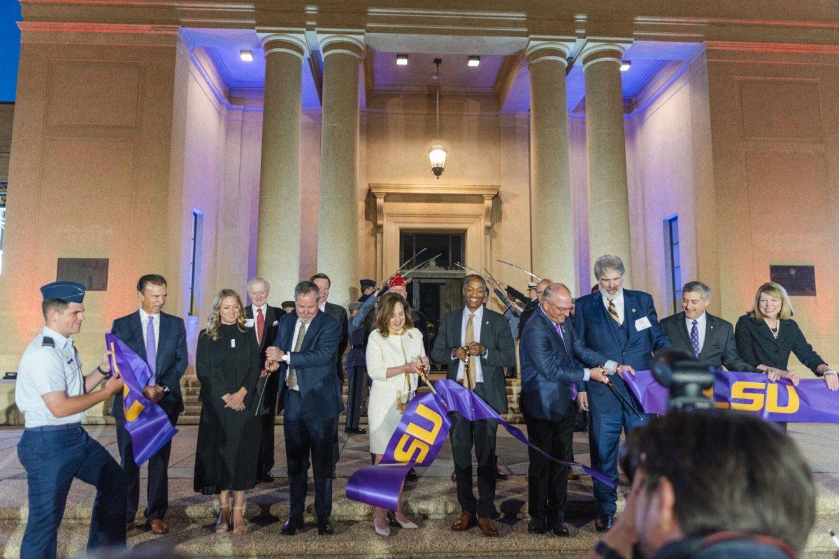 Governor Edwards, President Tate, Chair of the LSU Board of Supervisors R&#233;my Starns, and others cut the ribbon on Thursday, April 7, 2022, during the LSU Memorial Tower Museum ceremony on Tower Drive in Baton Rouge, La.