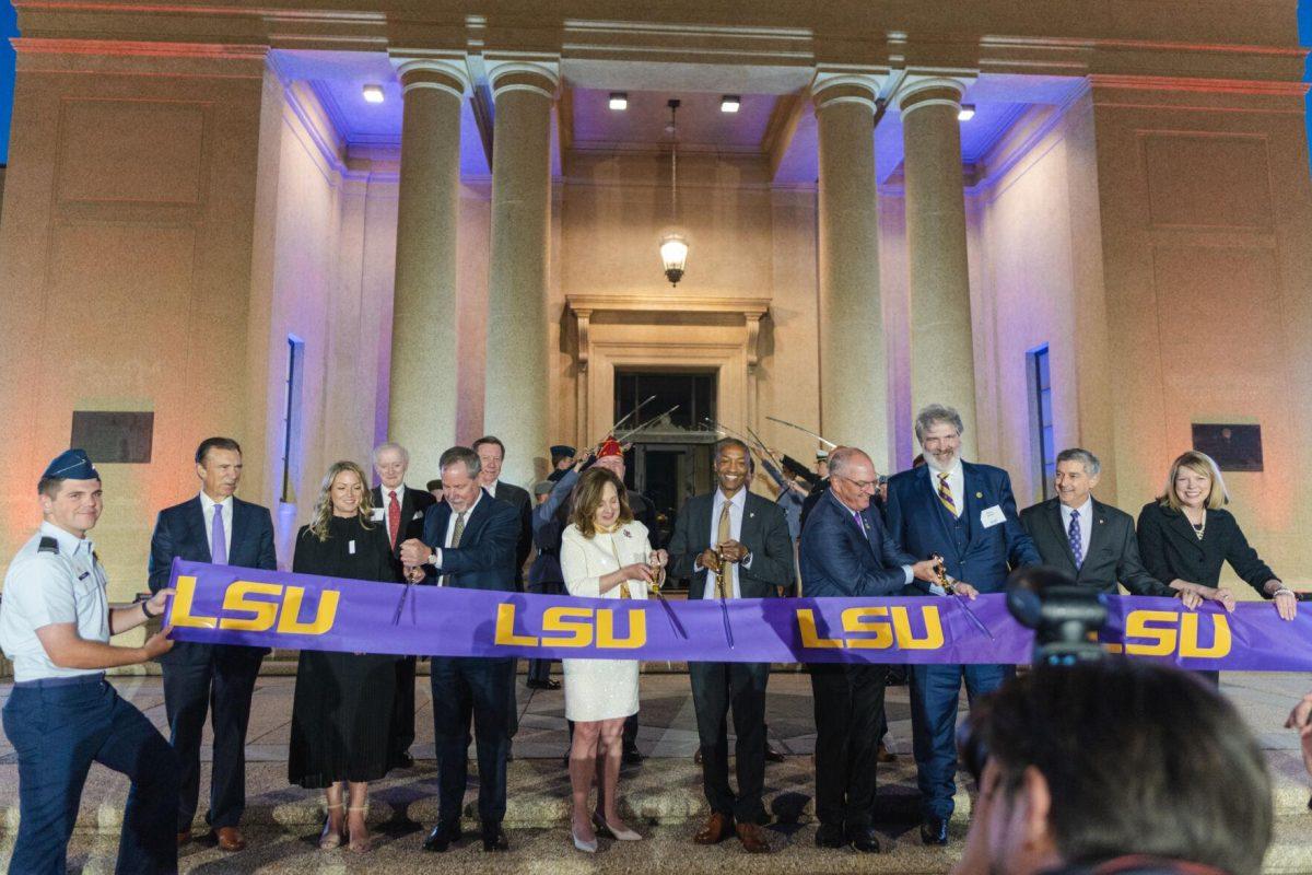 Governor John Bel Edwards, President William F. Tate, Chair of the LSU Board of Supervisors R&#233;my Starns, and others cut the ribbon on Thursday, April 7, 2022, during the LSU Memorial Tower Museum ceremony on Tower Drive in Baton Rouge, La.