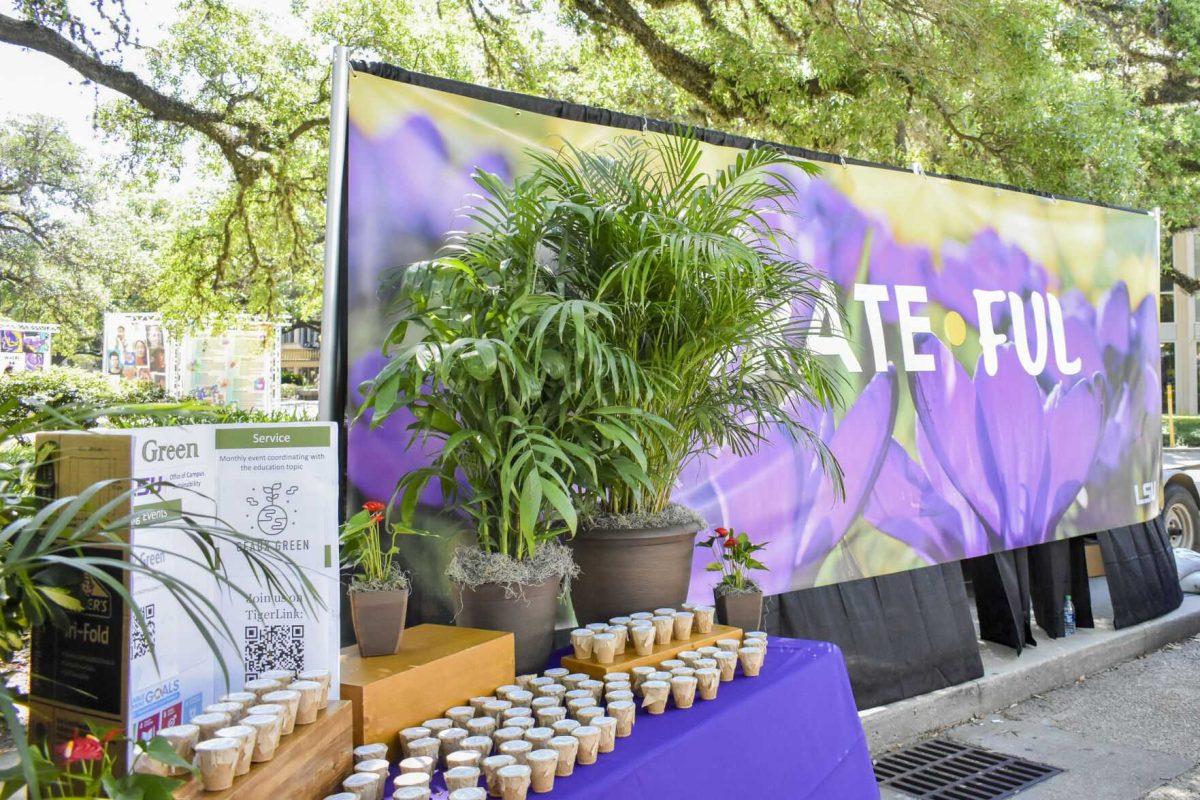 A &#8220;Geaux Green&#8221; posterboard, small pots of herbs and a &#8220;Grateful&#8221; sign are on display Wednesday, April 27, 2022, during the Grateful for Spring event on Tower Drive in Baton Rouge, Louisiana.