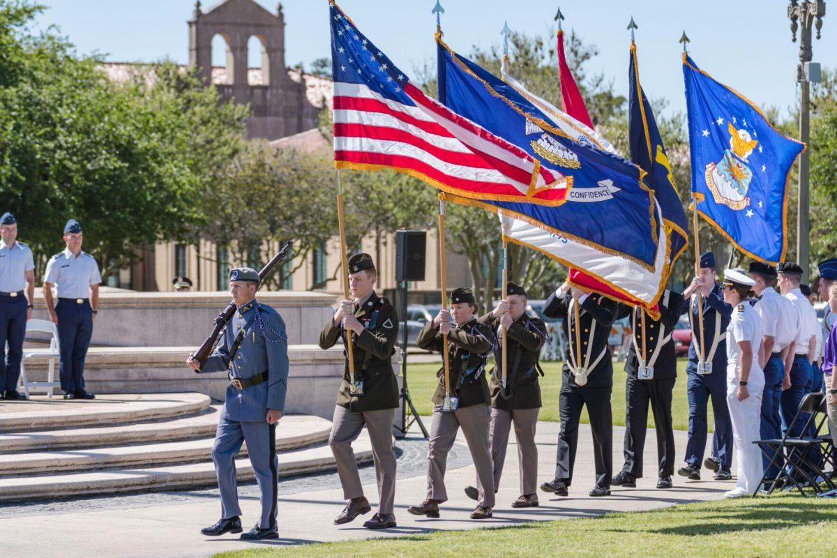 The color guard presents the colors on Thursday, April 7, 2022, as the change of command ceremony begins on the LSU Parade Ground on Highland Road in Baton Rouge, La.