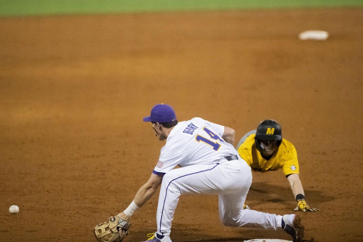 LSU baseball sophomore infield Jacob Bery (14) kneels to catch the ball at third base Thursday, April 21, 2022, during the game against the University of Missouri at Alex Box Stadium on Gourrier Avenue in Baton Rouge, Louisiana.