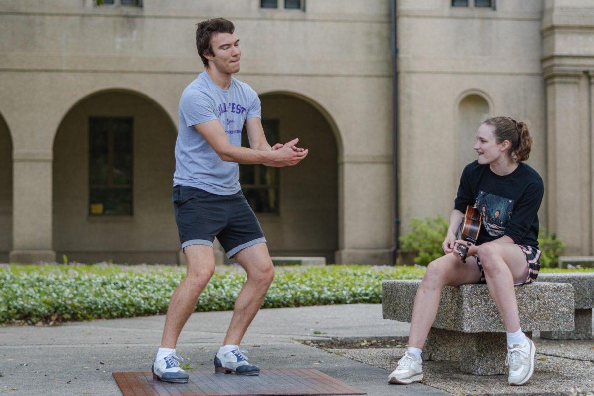 LSU sophomore math major Harrison Gietz (left) and sophomore film and tv major Jackie Johnston (right) perform a song and dance on Saturday, April 23, 2022, outside of Coates Hall in the Quad in Baton Rouge, La.