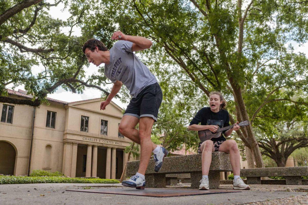 LSU sophomore math major Harrison Gietz (left) and sophomore film and tv major Jackie Johnston (right) perform a song and dance on Saturday, April 23, 2022, outside of Coates Hall in the Quad in Baton Rouge, La.