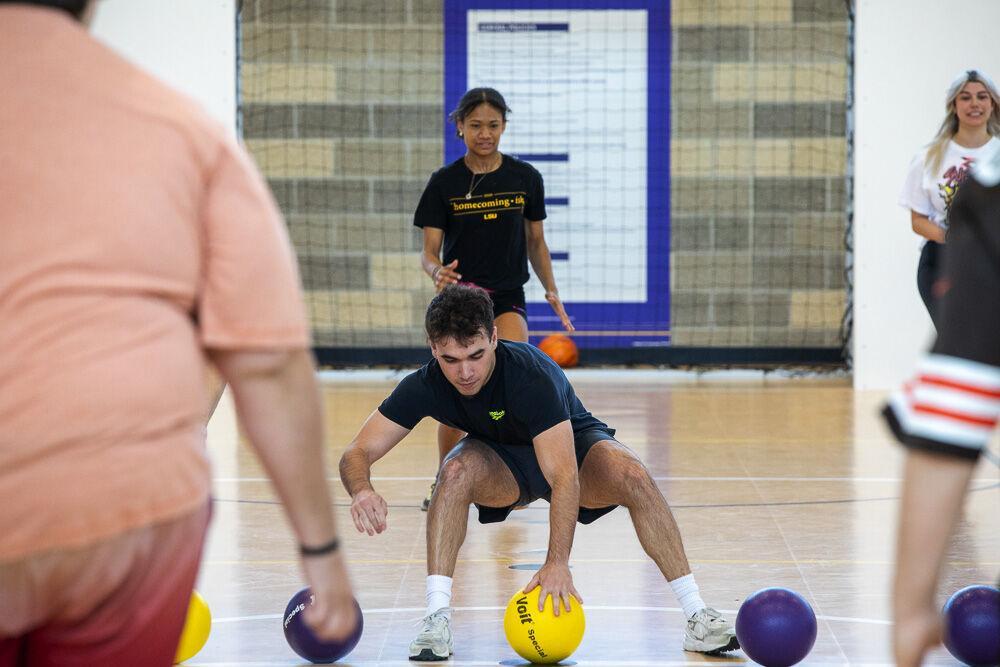 LSU Reveille news editor Joshua Archote gathers balls during the Student media dodgeball tournament Saturday, April 9, 2022 at LSU UREC.