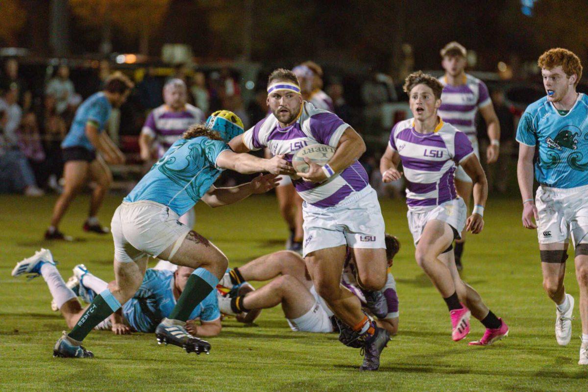 LSU Rugby flanker Hunter McCraine pushes past a defender on Friday, April 8, 2022, during LSU&#8217;s 89-0 win over Tulane at the UREC Fields on Gourrier Avenue in Baton Rouge, La.