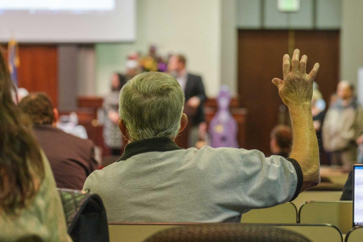 A Faculty Senator raises a hand during a vote on Thursday, March 24, 2022, inside the LSU Law Center on Highland Road in Baton Rouge, La.