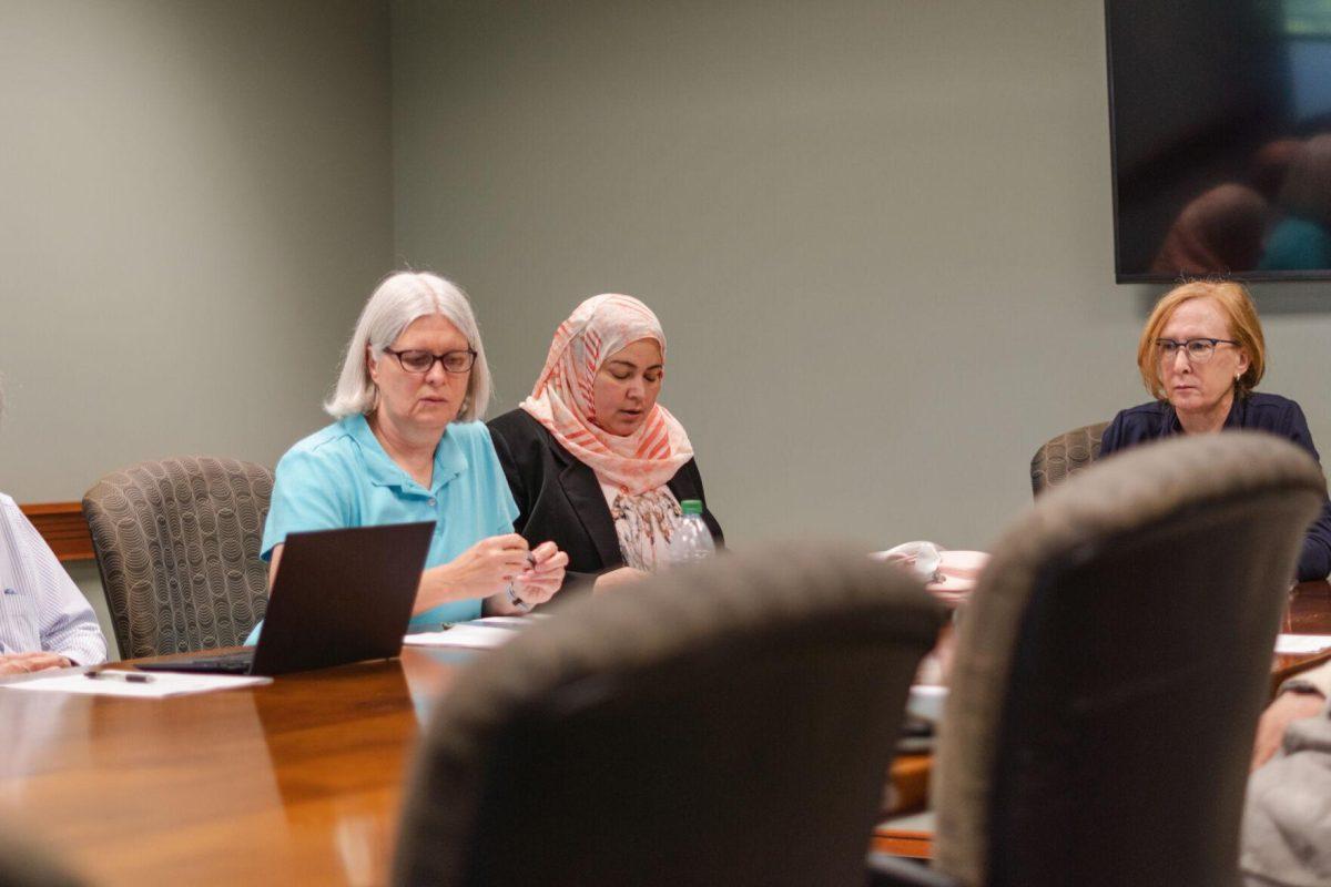 LSU Faculty Senate Secretary Marwa Hassan looks at the agenda on Wednesday, April 20, 2022, during the LSU Faculty Senate Executive Committee meeting inside the LSU Student Union on Highland Road in Baton Rouge, La.