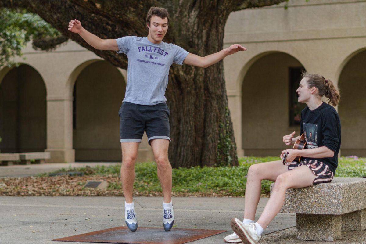 LSU sophomore math major Harrison Gietz (left) and sophomore film and tv major Jackie Johnston (right) perform a song and dance on Saturday, April 23, 2022, outside of Coates Hall in the Quad in Baton Rouge, La.