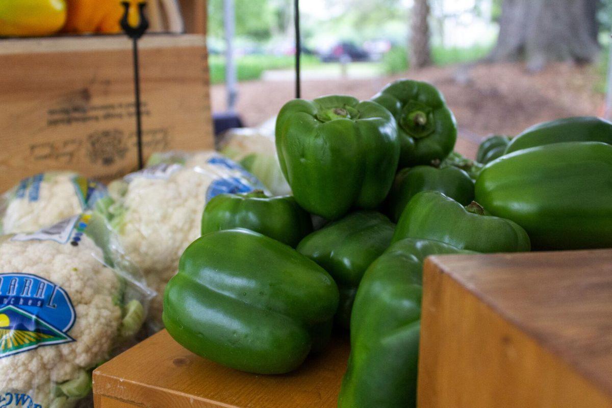 Green bell peppers glisten Wednesday, April 6, 2022, for the Farmer's Market on Tower Drive.