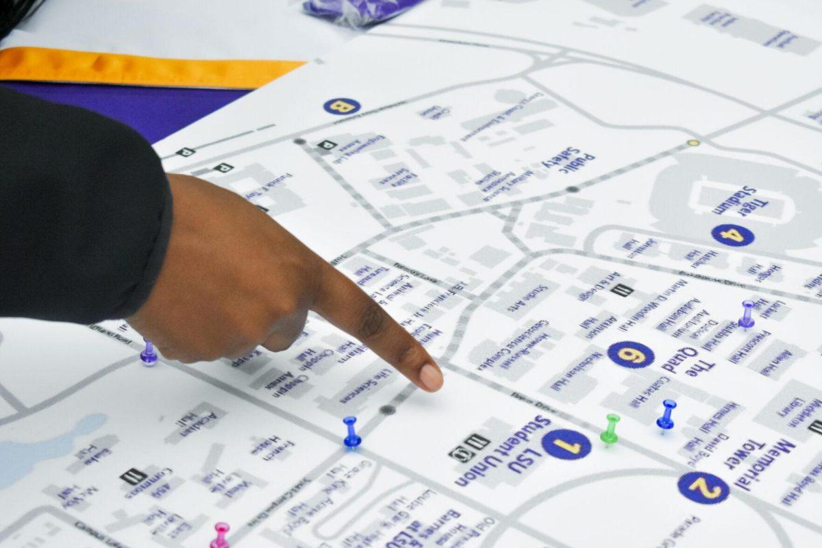 A LSU student points to an unsafe spot on campus for pedestrians Monday, April 11, 2022, on Tower Drive in Baton Rouge, Louisiana.