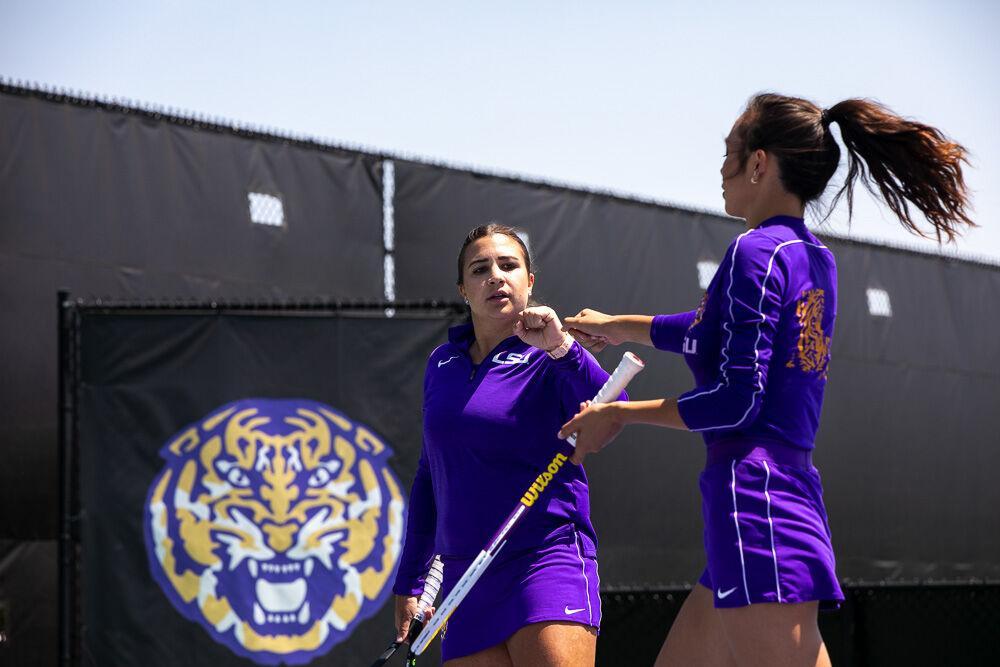 LSU women&#8217;s tennis graduate student Ena Babic fist bumps graduate student Taylor Bridges after winning the rally Friday, April 8, 2022, during LSU&#8217;s 7-0 loss against Texas A&amp;M in the LSU Tennis Complex on Gourrier Avenue in Baton Rouge.