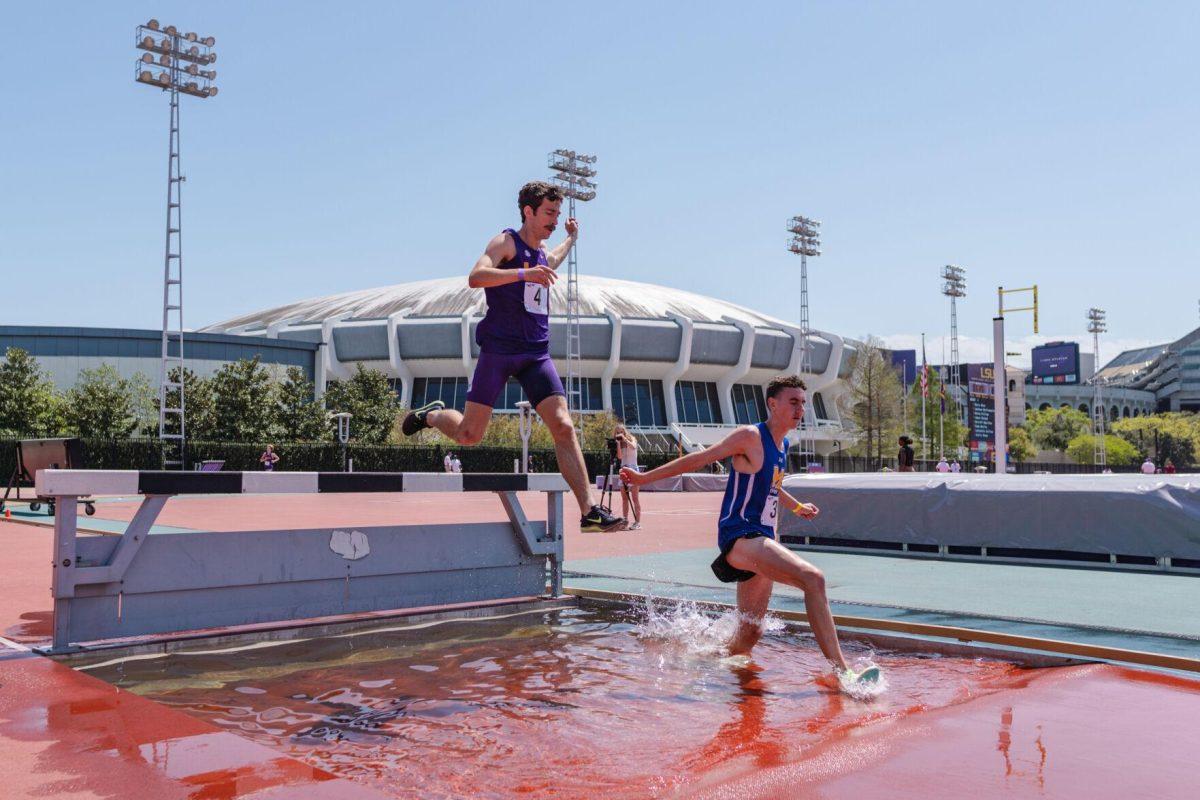 LSU track and field distance sophomore Garrett Hamilton leaps over the barrier on Saturday, April 2, 2022, during the 3000m steeplechase at the Battle on the Bayou track meet at Bernie Moore Stadium in Baton Rouge, La.