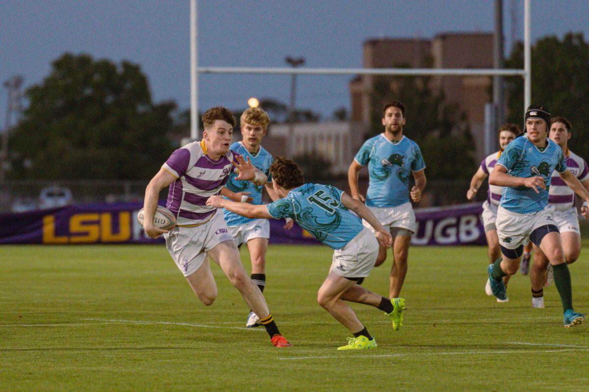 LSU Rugby outside center Finlay Neilson evades a Tulane player on Friday, April 8, 2022, during LSU&#8217;s 89-0 win over Tulane at the UREC Fields on Gourrier Avenue in Baton Rouge, La.