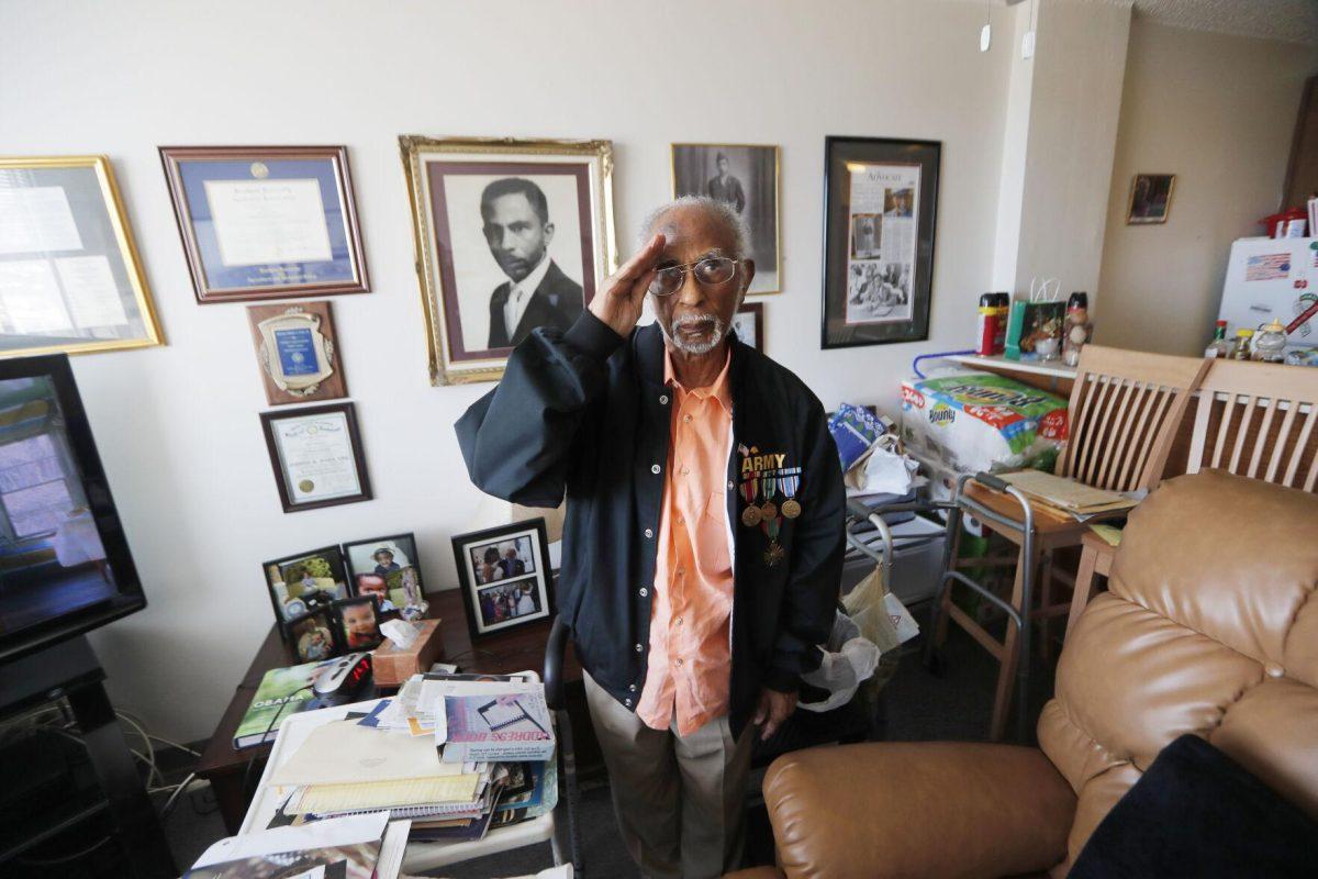 FILE - World War II veteran Johnnie Jones, Sr. poses for a portrait at his home in Baton Rouge, La., May 28, 2019. His goddaughter, Mada McDonald, tells WAFB-TV that Jones died on Saturday, April, 23, 2022, at a veterans' home in Jackson, La. (AP Photo/Gerald Herbert, File)