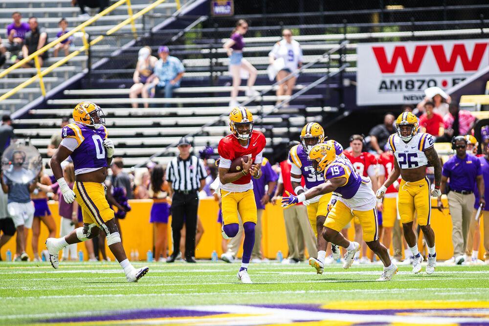 LSU football junior quarterback Jayden Daniels (5) scrambles for a first down Saturday, April 23, 2022, during LSU football&#8217;s annual spring football game with White winning 51-31 over Purple in Tiger Stadium.