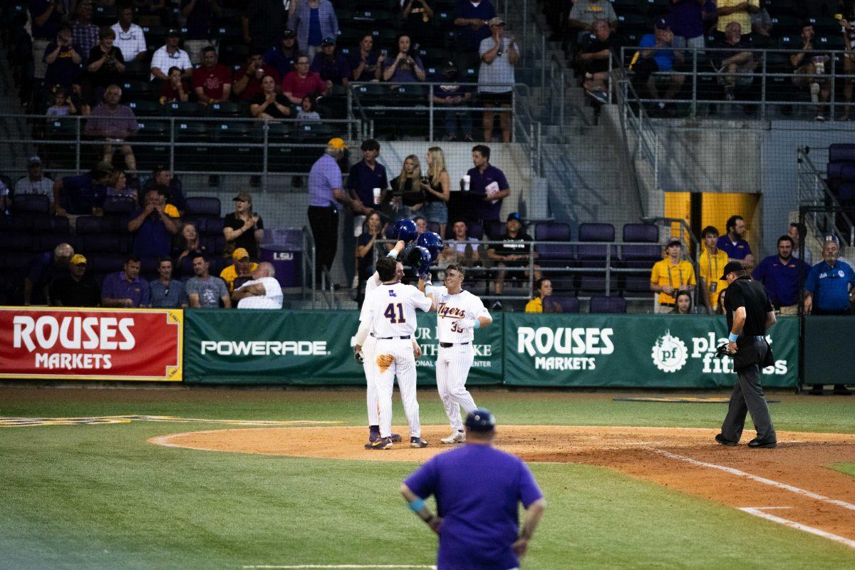 LSU baseball freshman outfielder Josh Stevenson (41), graduate student catcher Tyle McManus (26), and freshman outfielder Josh Pearson (39) bump helmets together Monday, May, 3, 2022, during the Tigers&#8217; 10-6 win against Nicholls at Alex Box Stadium in Baton Rouge, La.