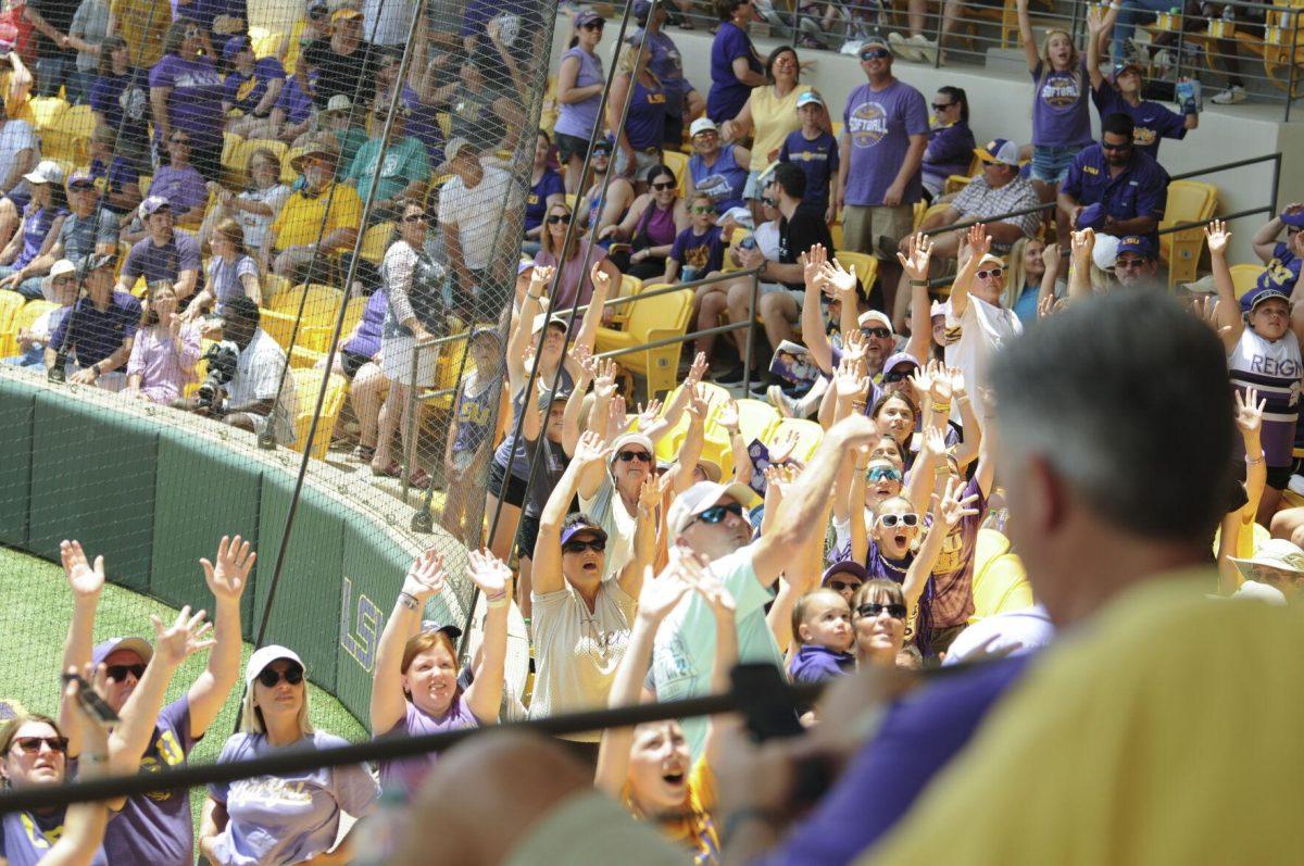 The crowd raises their hands for the t-shirt toss Saturday, April 30, 2022, during LSU&#8217;s 6-1 defeat against Florida at Tiger Park on Skip Bertman Drive in Baton Rouge, La.