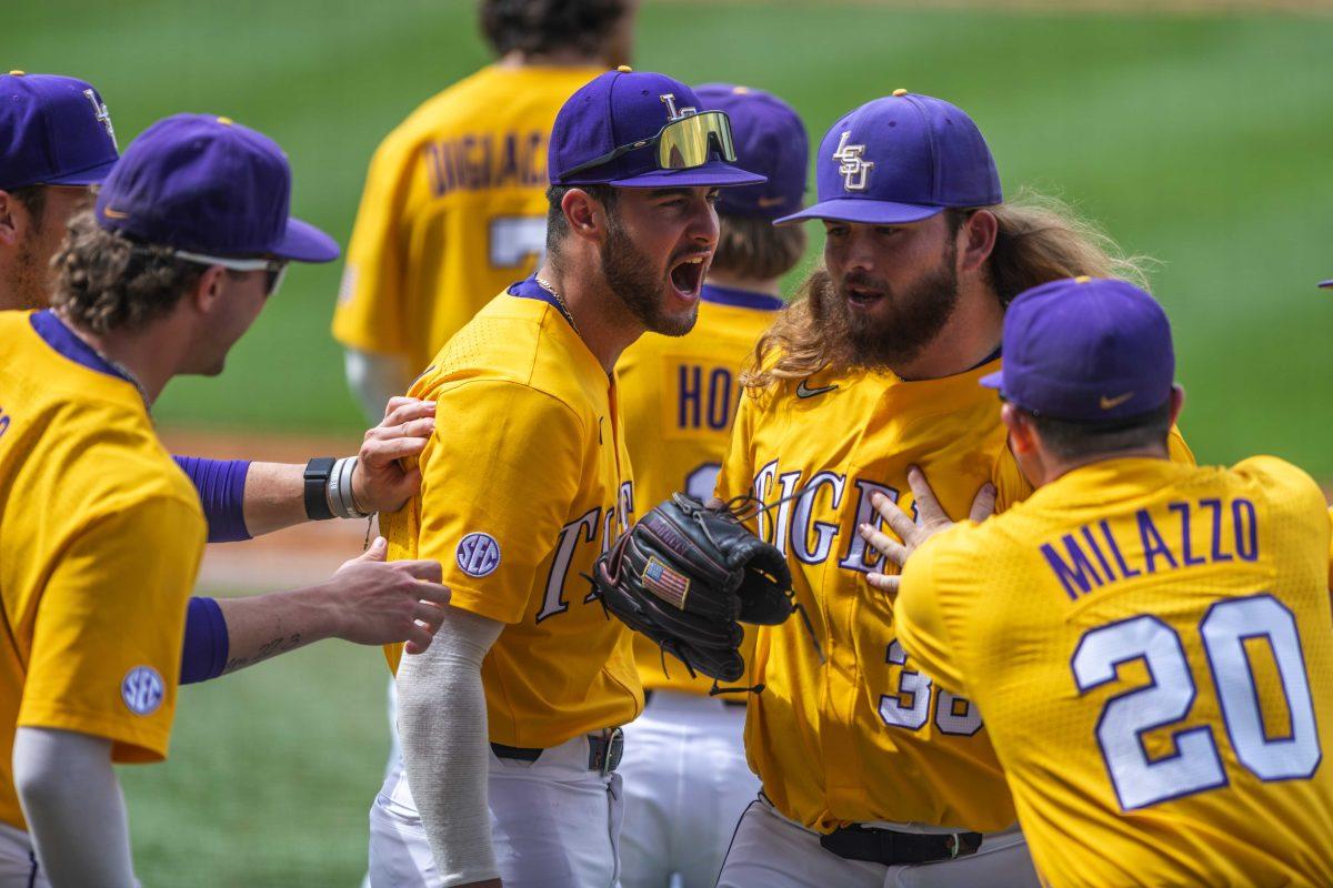 LSU baseball players surround sophomore left-handed pitcher Riley Cooper (38) Saturday, April 23, 2022, as he strikes out the final Missouri player of Inning 8 during LSU's 8-6 win over Missouri at Alex Box Stadium.