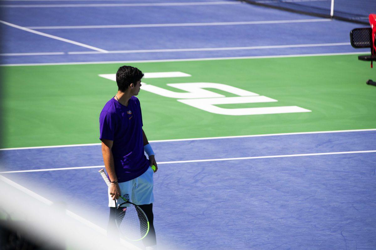 LSU men's tennis sophomore Joao Garca stands with a tennis ball in his hand Sunday, Feb. 13, 2021 during LSU's 6-1 win over Purdue at the LSU Tennis Complex on Gourrier Avenue in Baton Rouge, La.