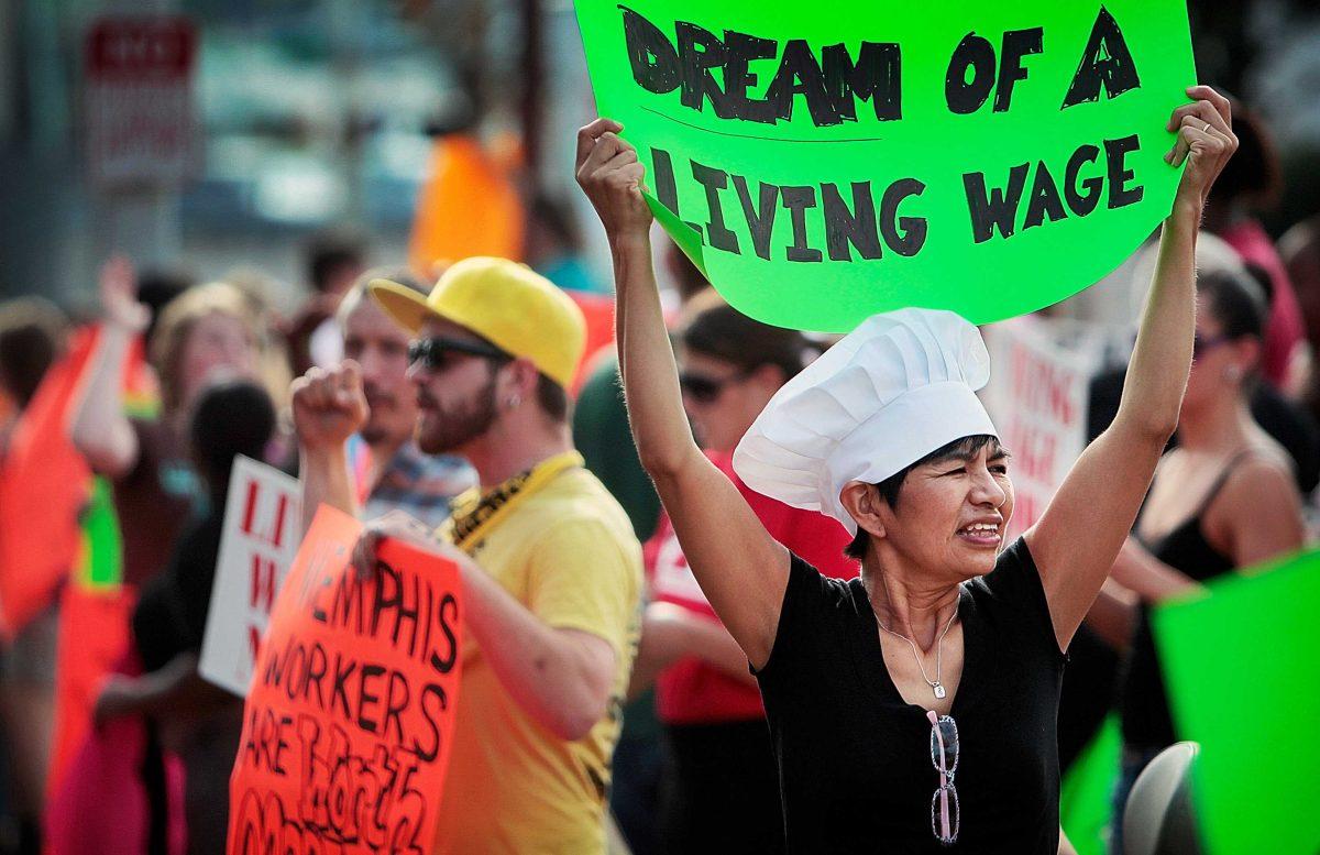 In this Aug. 29, 2013, file photo, Christina Condori joins a crowd of fast-food workers and their supporters in protest, while picketing outside of a McDonald's restaurant in Memphis, Tenn. Thousands of fast-food workers and their supporters have been staging protests across the country to call attention to the struggles of living on or close to the federal minimum wage. The push raises the question of whether the economics of the fast-food industry allow room for a boost in pay for its workers.