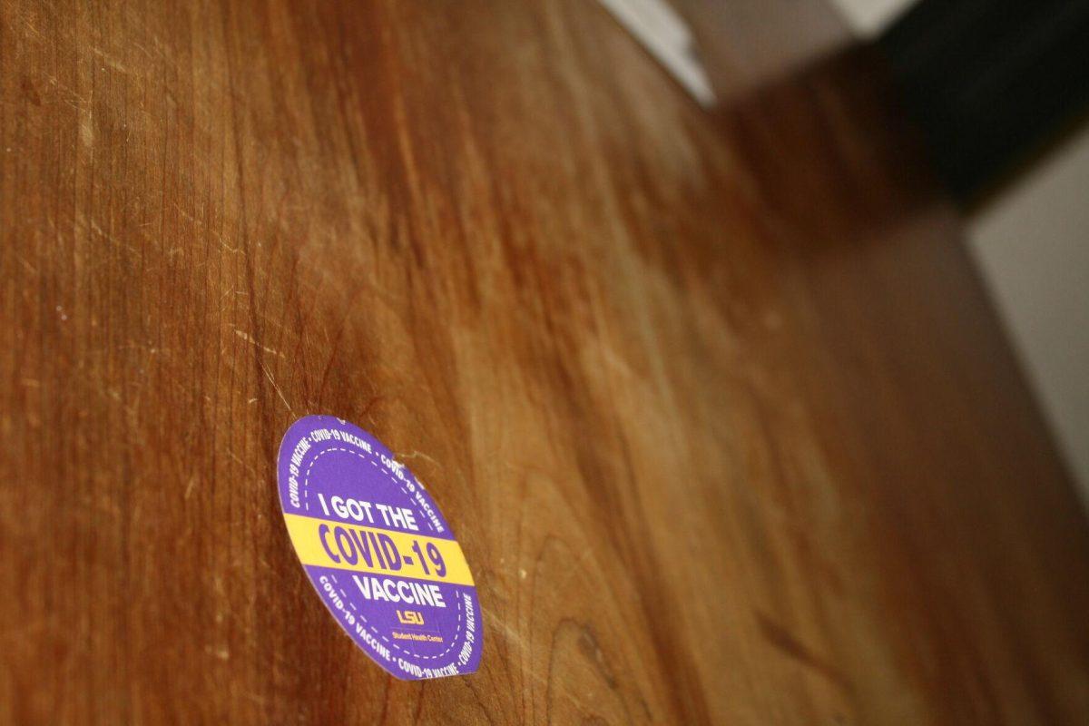 A sticker from the Student Health Center saying "I Got the COVID-19" is stuck to the door of Lockett Hall's first floor men's room on Wednesday, May 18, 2022.