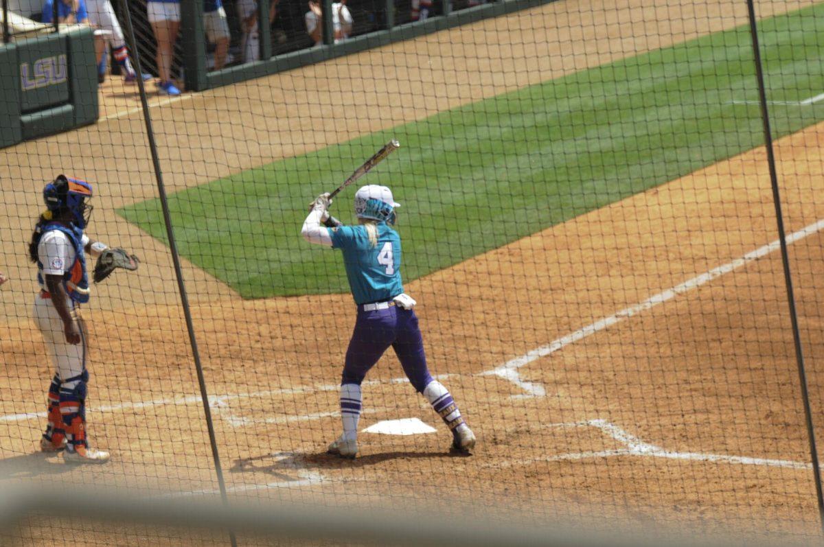 LSU freshman outfielder McKenzie Redoutey (4) swings at the pitch Saturday, April 30, 2022, during LSU&#8217;s 6-1 defeat against Florida at Tiger Park on Skip Bertman Drive in Baton Rouge, La.