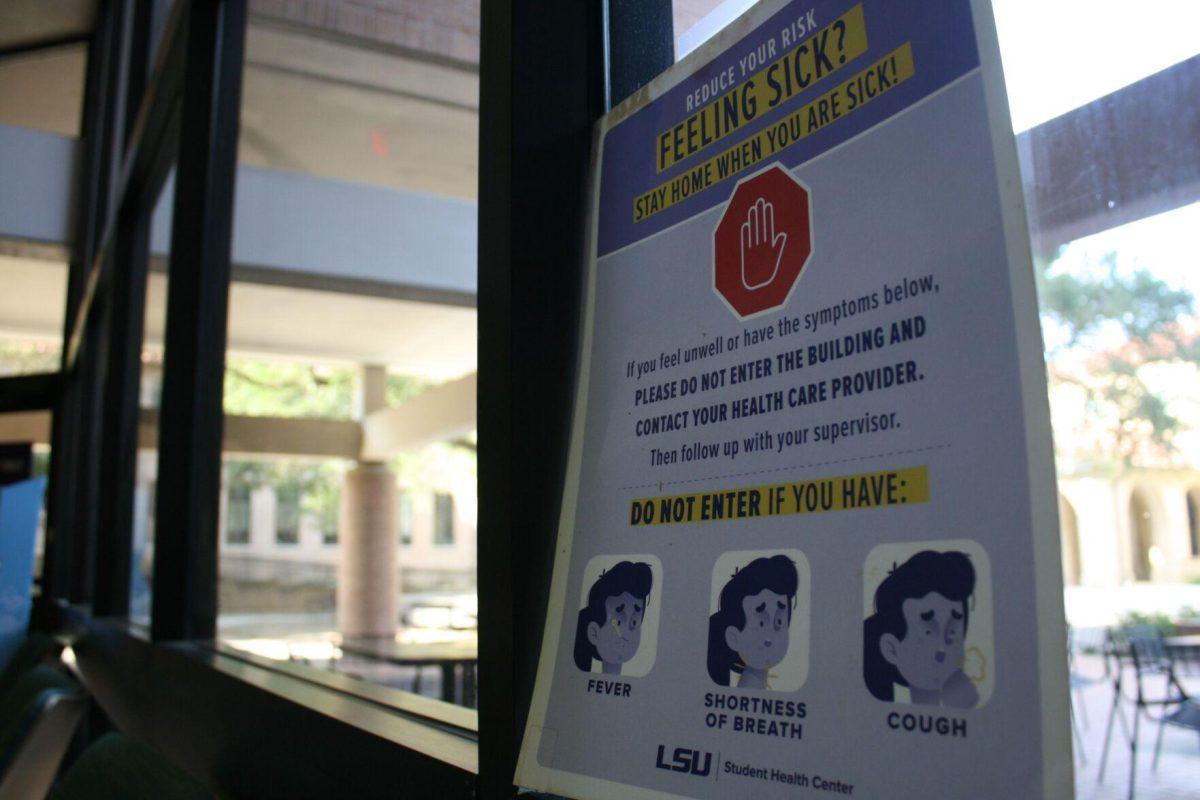 A "Feeling Sick?" sign hangs inside the Art and Design Building's first floor lobby on Wednesday, May 18, 2022.