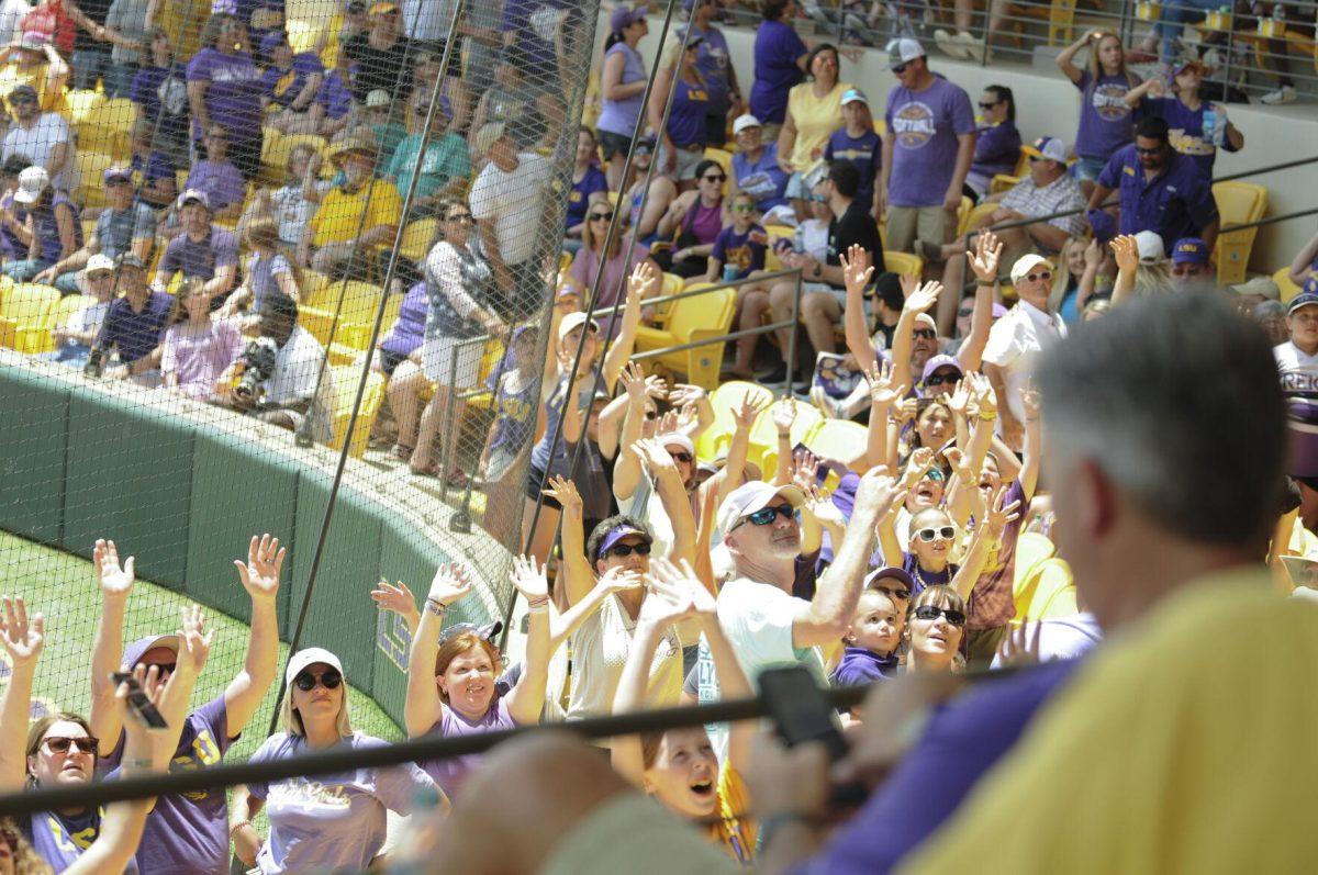 The crowd raises their hands for the t-shirt toss Saturday, April 30, 2022, during LSU&#8217;s 6-1 defeat against Florida at Tiger Park on Skip Bertman Drive in Baton Rouge, La.